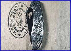 Hand engraved Spiderco CaraCara knife