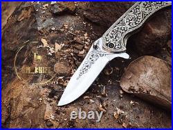 Handmade folding knife with hand engraved handle and blade