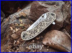 Handmade folding knife with hand engraved handle and blade
